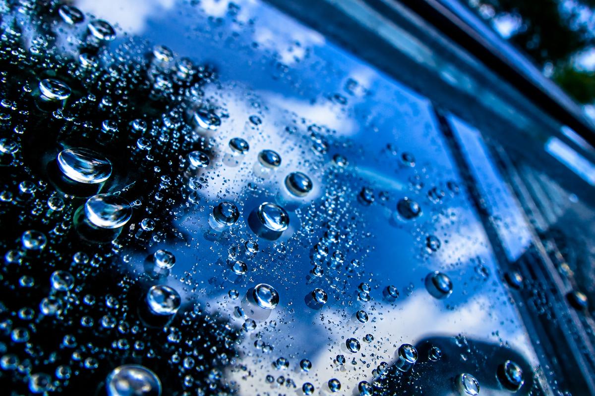 Water beads on a freshly cleaned window surface